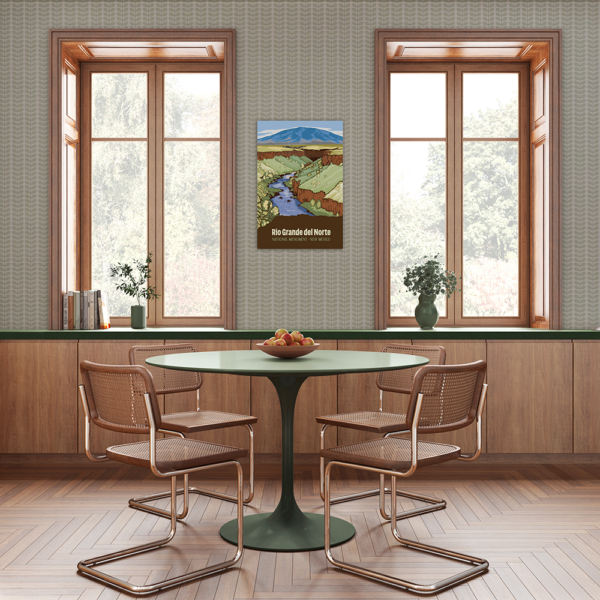 An aluminum print hung up on a wall in a dining room.
