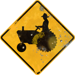 Street Sign with Tractor and Driver Crossing symbol. Vintage looking sign with digitally printed bullet holes.