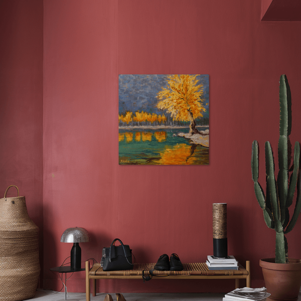 An aluminum print hung up on a wall above a bench.