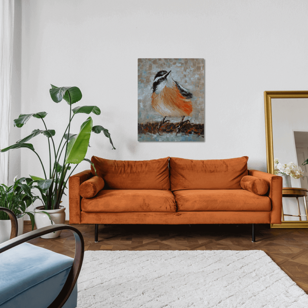 A print of Arrival Time hung up on a wall above a couch.